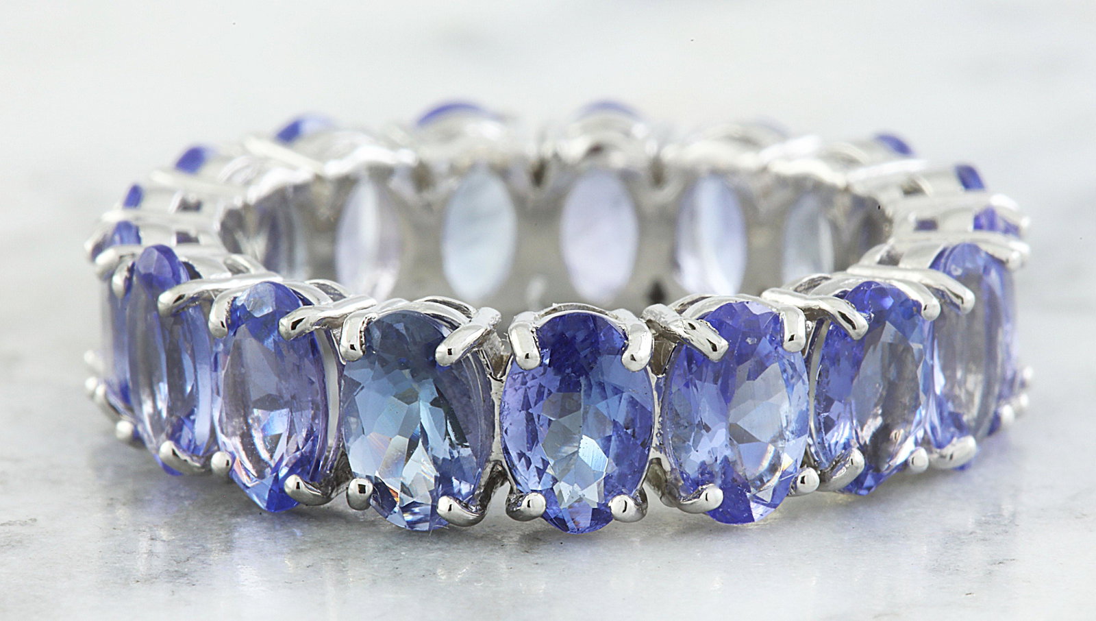 5.78 CTW Tanzanite 18K White Gold Ring: 5.78 CTW Tanzanite 18K White Gold Ring Manufacturer's Suggested Retail Price: $ 2300.00 Stamped: 18K Total Ring Weight: 5.2 Grams Tanzanite Weight 5.78 Carat (6.00x4.00 Millimeters) Face Measures: 6.0