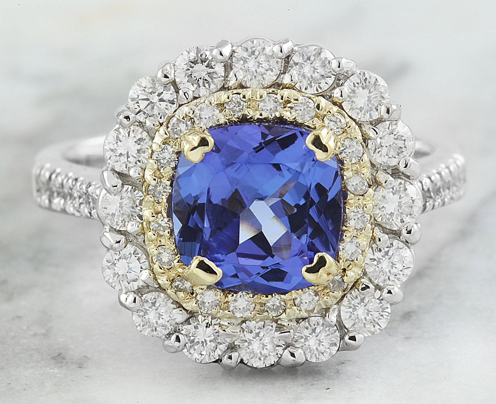2.71 CTW Tanzanite 18K Two Tone Gold Diamond Ring: 2.71 CTW Tanzanite 18K Two Tone Gold Diamond Ring Manufacturer's Suggested Retail Price: $ 5200.00 Stamped: 18K Total Ring Weight: 6 Grams Tanzanite Weight 2.50 Carat (7.70x7.70Millimeters) Diamond We