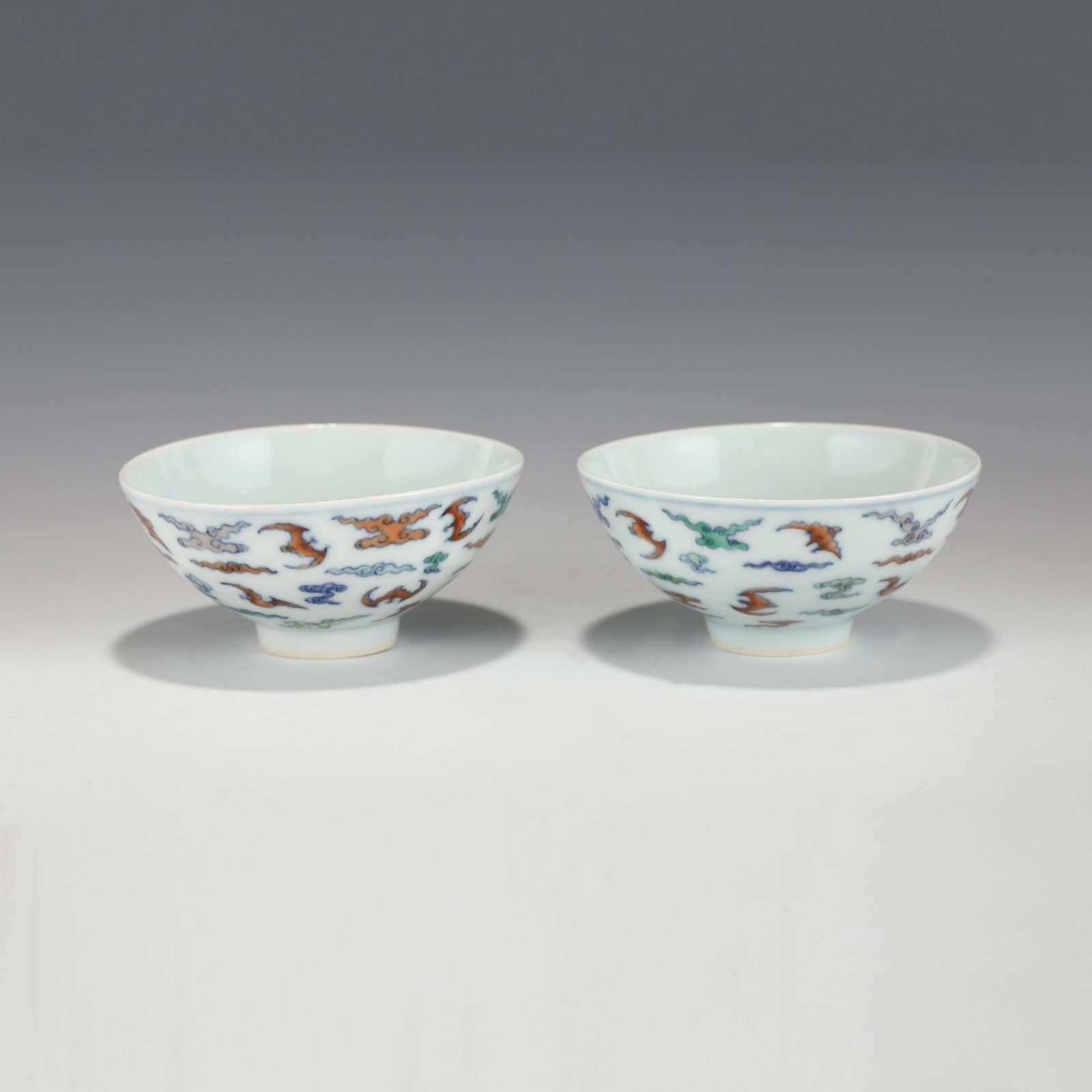 PAIR OF YONGZHENG FAMILLE ROSE FU BATS BOWLS: Dimensions (cm): Heigth: 4.7?Diam.: 9.8 Pair Of Chinese Qing Dynasty YongZheng Famille Rose Fu Bats Porcelain Bowls. The bowls has an open mouth, rounded lip rim, thick, deep arced body, raised with s