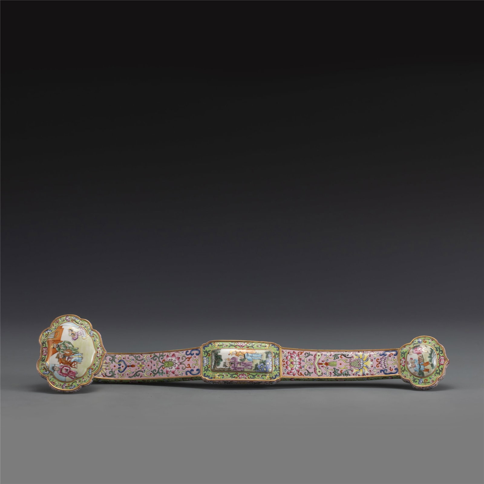 QING QIANLONG FAMILLE ROSE LOTUS RUYI: Dimensions: Length: 48cm, Width: 9.5cm, Height: 6.8cm. Chinese Qing Dynasty Qianlong Famille Rose Lotus Ruyi. Potted in a traditional ruyi has a long S-shaped handle and a head fashioned like a fist, 