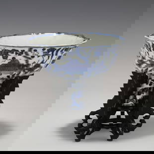 MING XUANDE BLUE & WHITE HIGH-FOOTED BOWL ON STAND: Dimensions: Width: 16cm, Height: 11cm Chinese Ming Dynasty Xuande Blue and White Dragon Porcelain High-footed Bowl On Carved Hardwood Stand. This bowl has a lightly flaring open mouth-rim, a inward st