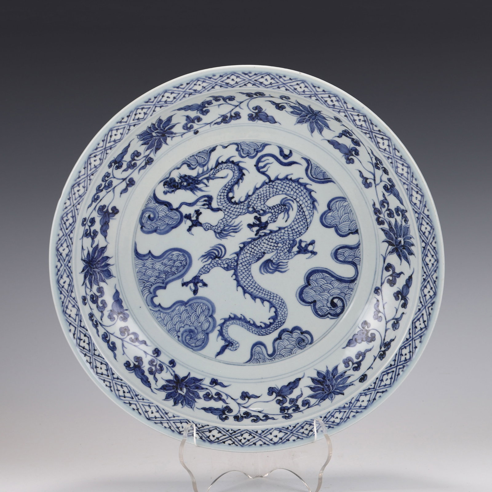 YUAN BLUE & WHITE DRAGON CHARGER: Dimensions: Height: 7cm, Diam: 38cm Chinese Ming Dynasty Period, Blue and white Dragon porcelain plate. The plate has a broad wide central interior, rounded rim, raised on correspondence footed ring b