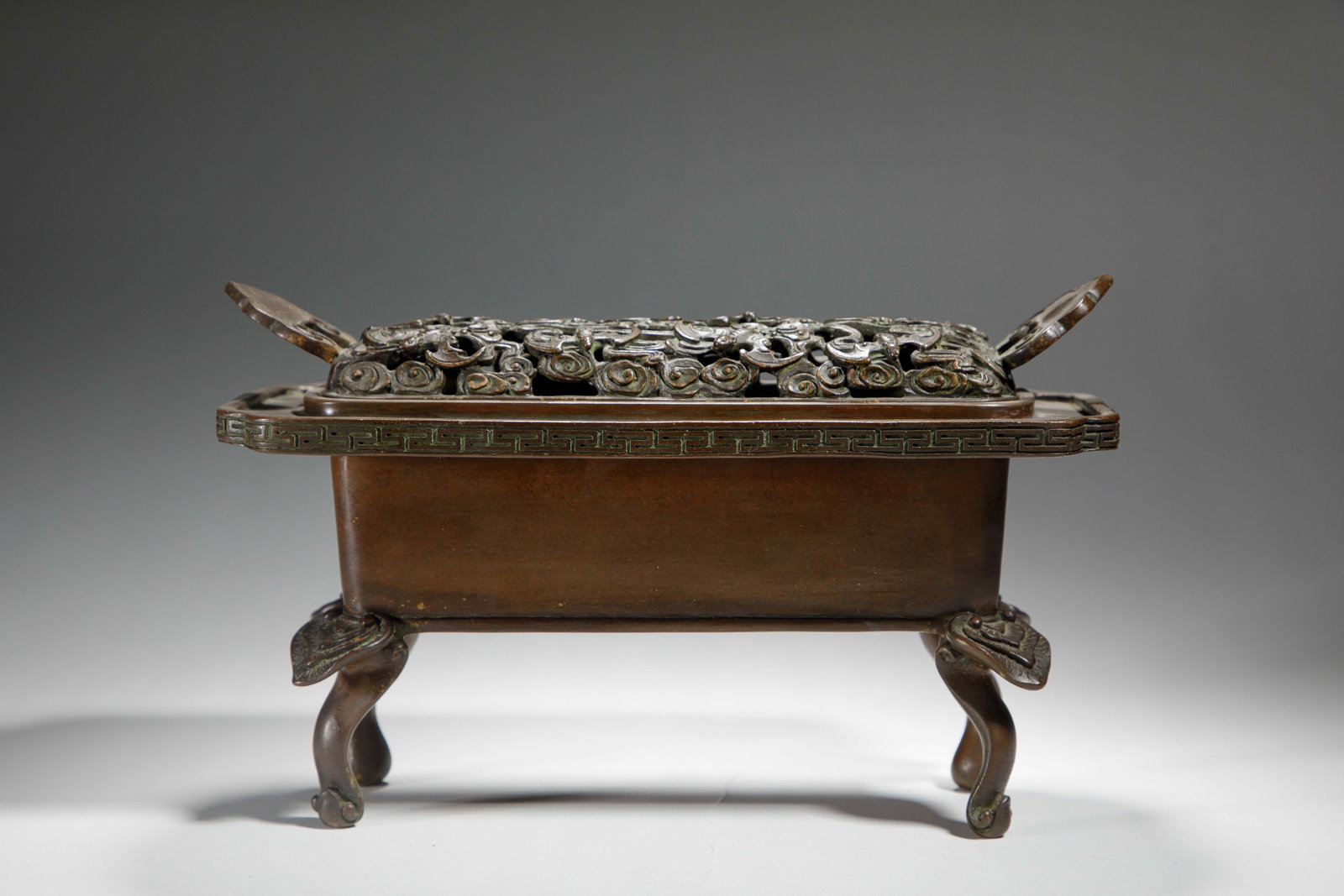 A CHINESE BRONZE CENSER WITH PIERCED COVER (1 of 9)