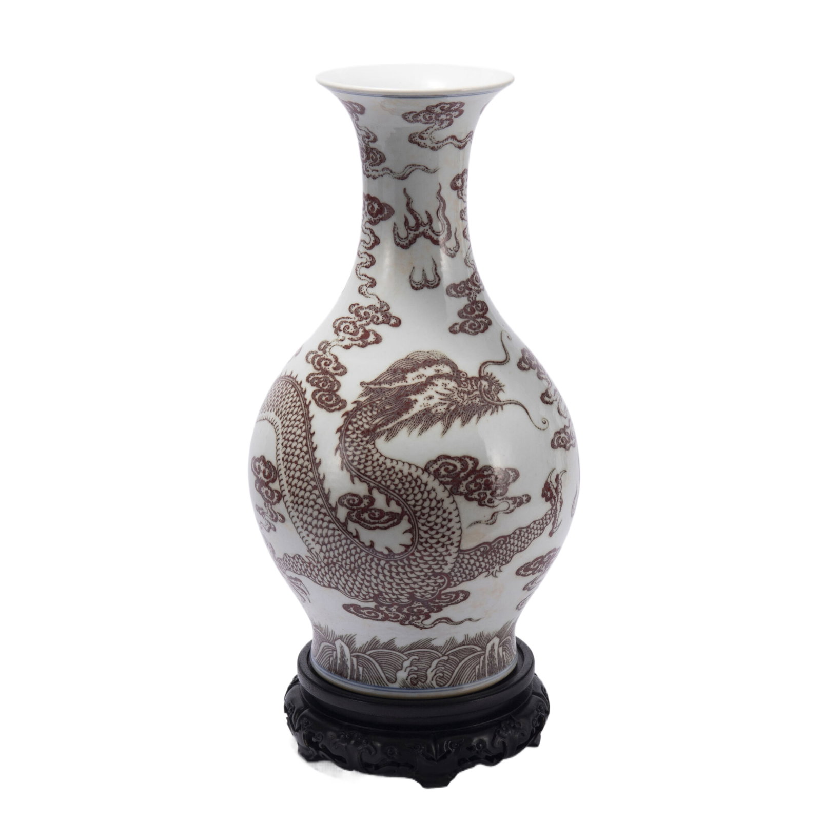 A CHINESE UNDERGLAZE RED PORCELAIN VASE: Dimensions:Diam. 20.1 cm. H. 41.3 cm. The pear-shaped vase is painted dragon among flaming clouds in copper red, all above lishui waves.
