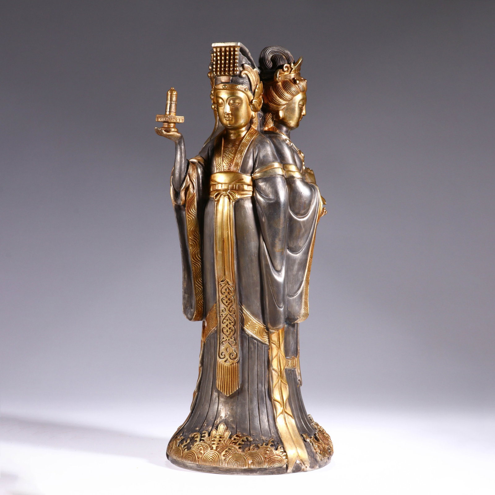 CHINESE GILT-SILVER DOUBLE FIGURE STATUE: Dimensions:H. 40 cm. W. 18 cm. A fine Chinese gilt-silver double figure statue, depicting two regal figures in flowing court robes. The front figure wears an ornate headdress and holds a