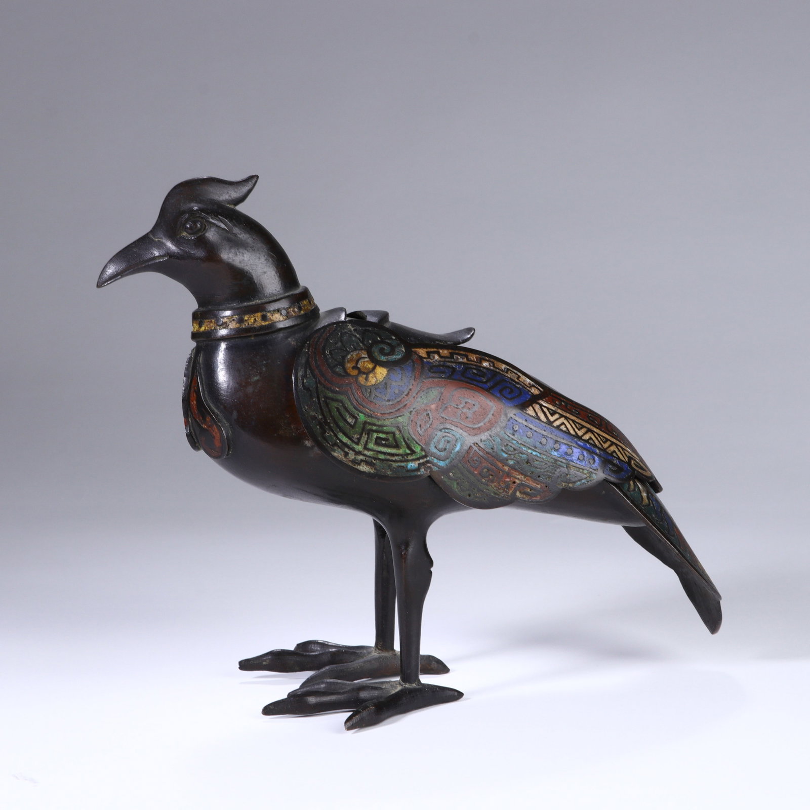 A CHINESE CLOISONNÉ ENAMEL BIRD-FORM CENSER: Dimensions:18x22 cm. This Chinese censer is cast in the form of a mythical auspicious bird, crafted from dark patinated bronze with vibrant cloisonné enamel decoration. The bird’s