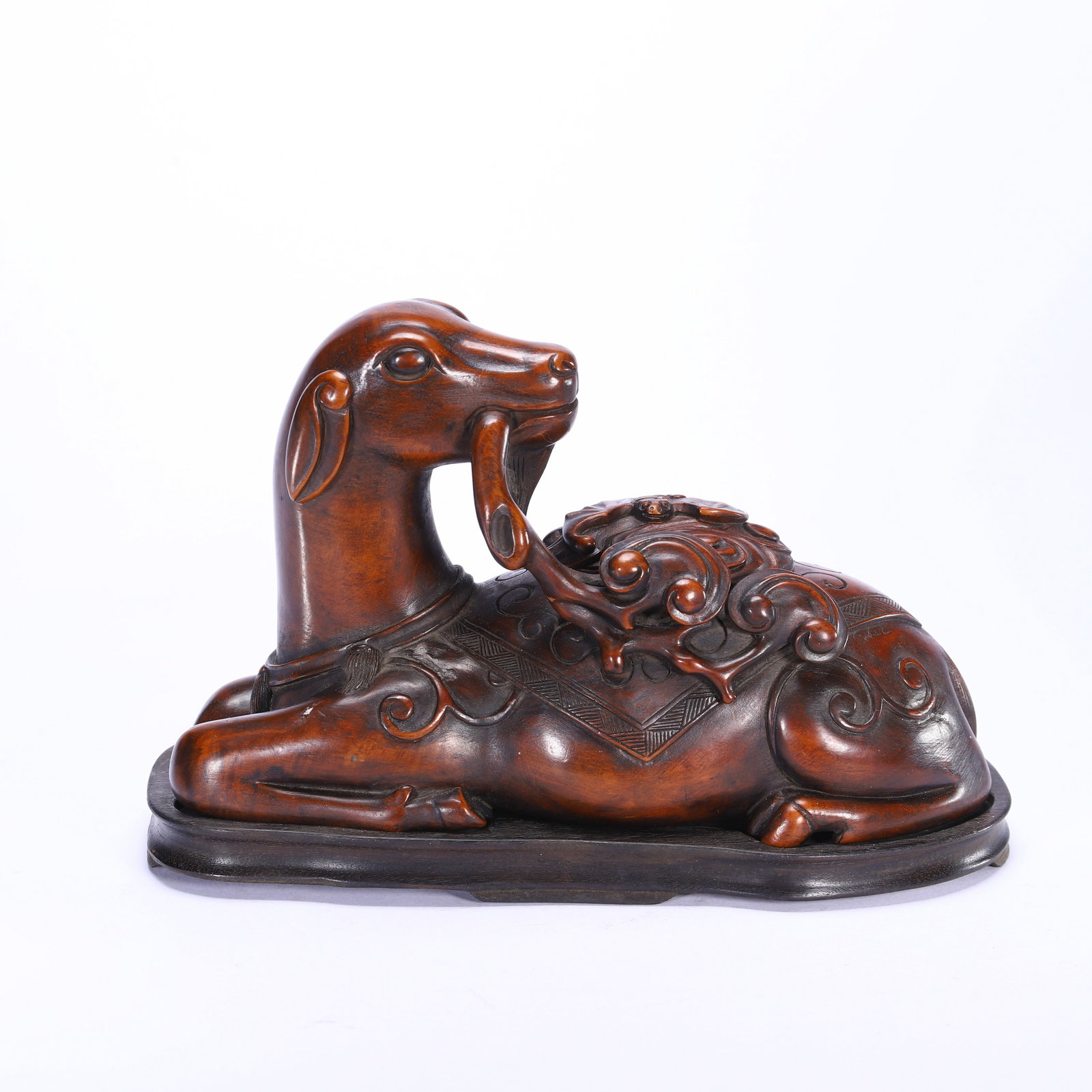 CHINESE BOXWOOD AUSPICIOUS BEAST FIGURE: Dimensions:L. 19.5 cm. W. 10 cm. H. 13.5 cm. Weight 570 grams. A fine Chinese boxwood carving of a reclining auspicious beast, depicted in a relaxed recumbent pose with a lingzhi fungus branch held in