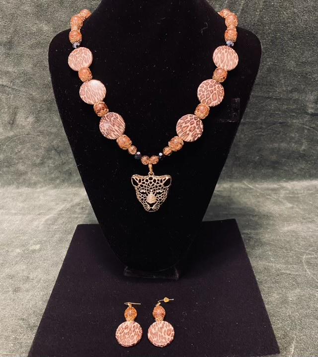 Leopard Necklace, Earring Set: Gold Leopard necklace with brown and animal pattern beads. The lighting gave some of the pics a pink tint but it is brown.