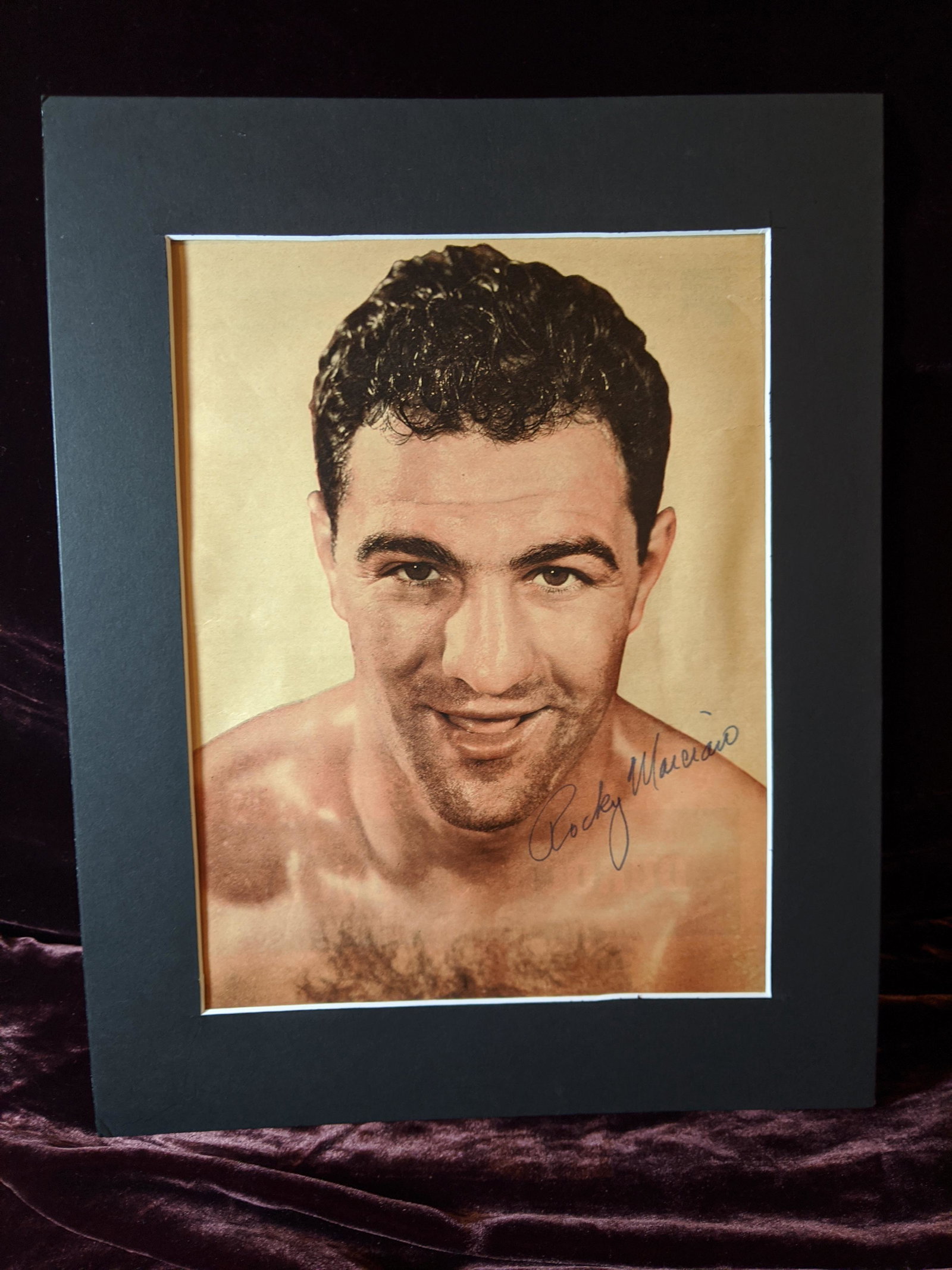 Rocky Marciano autographed magazine photo: A Rocky Marciano autographed matted magazine photo authenticated by Vintage Sports. See photos for condition.