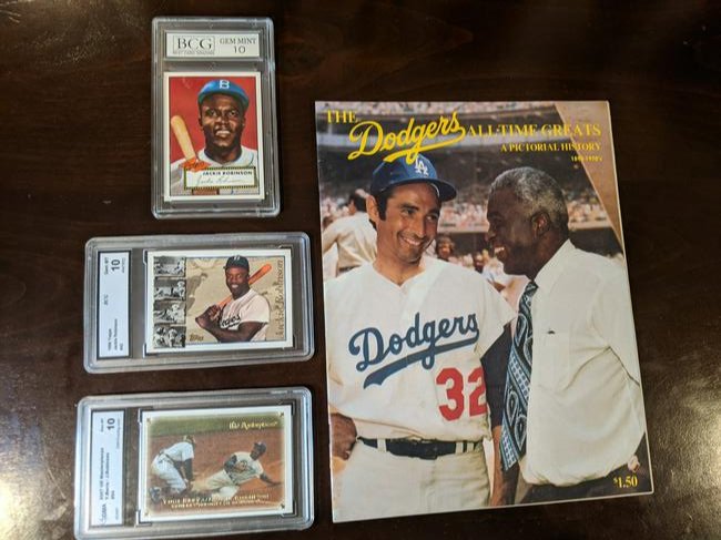 Jackie Robinson lot: Dodgers All-Time Greats Pictorial History 1890-1970s magazine with Jackie Robinson, 1995 Topps Archives Jackie Robinson #18, 1996 Topps Jackie Robinson 342, 2007 Upper Deck Masterpieces Jackie Robinso