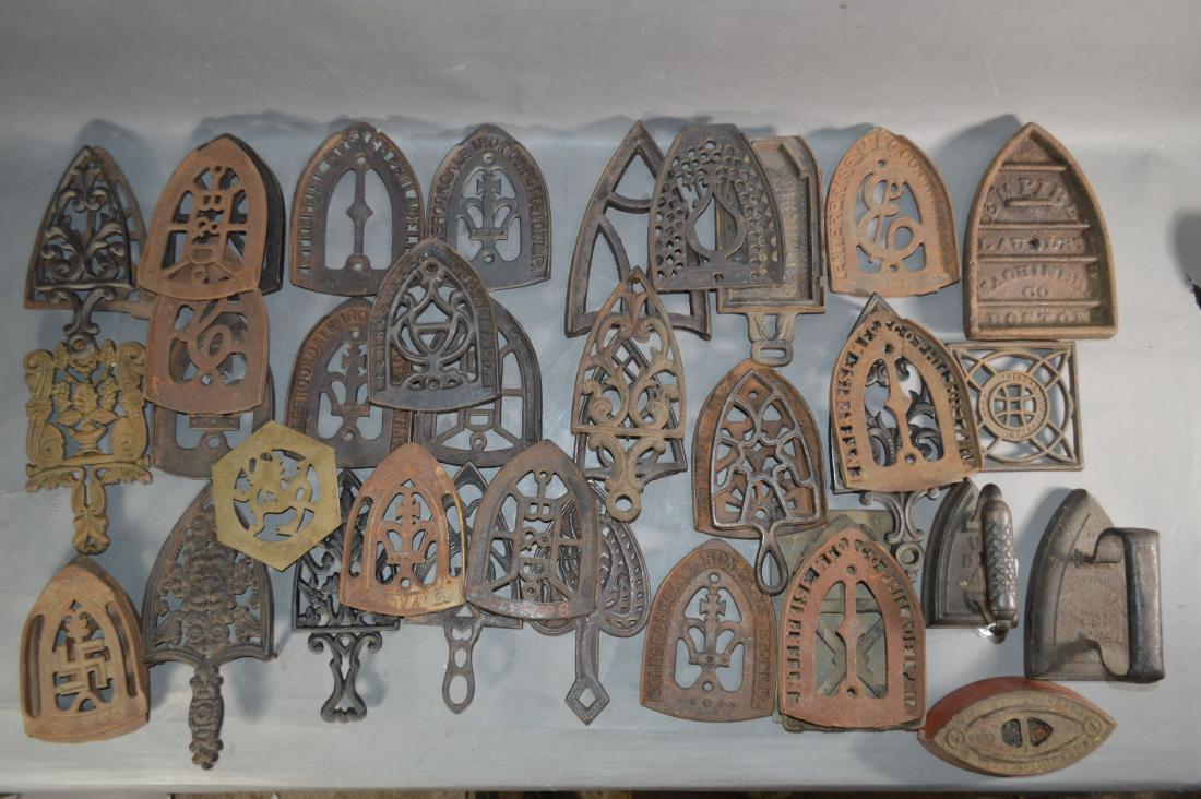 36 ANTIQUE CAST IRON TRIVETS AND 4 SAD IRONS: 36 ANTIQUE CAST IRON TRIVETS AND 4 SAD IRONS