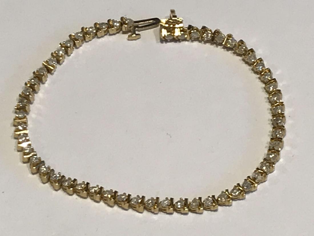 14K GOLD AND DIAMOND TENNIS BRACELET: 14K GOLD AND DIAMOND TENNIS BRACELET