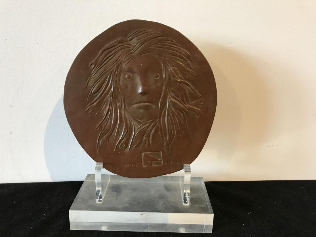 A LEONARD BASKIN CIRCULAR BRONZE PLAQUE "ATHENAS: A LEONARD BASKIN CIRCULAR BRONZE PLAQUE "ATHENAS SHIELD". 7" D 1969, 98/250 WITH ORIGINAL LUCITE STAND