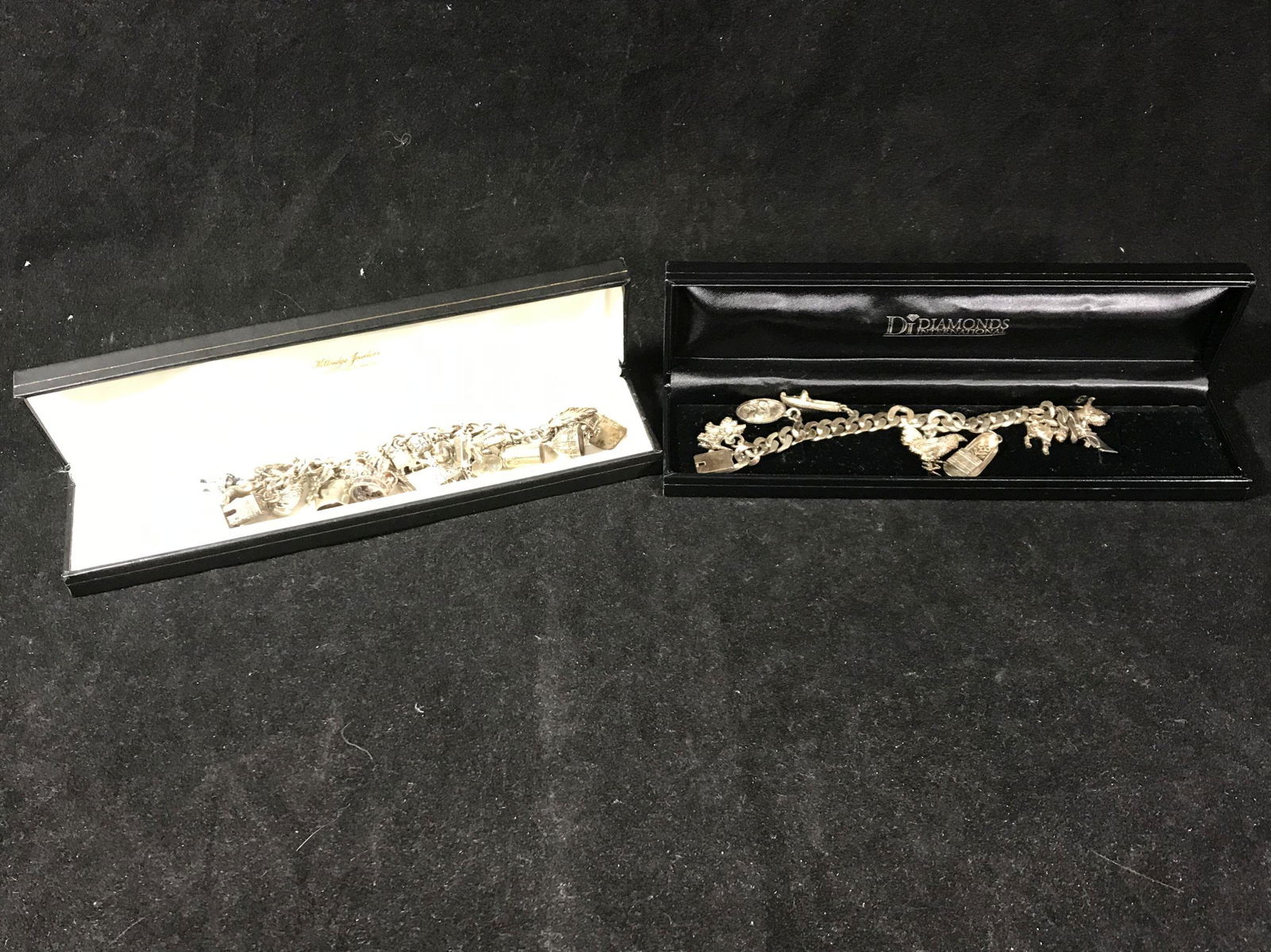 A PAIR OF MEXICAN SILVER CHARM BRACELETS 8"LONG: A PAIR OF MEXICAN SILVER CHARM BRACELETS 8"LONG