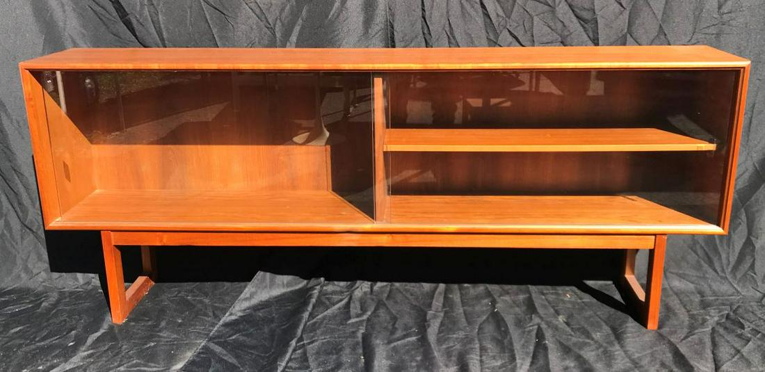 A VINTAGE TEAK DANISH MODERN SIDEBOARD WITH GLASS DOORS: A VINTAGE TEAK DANISH MODERN SIDEBOARD WITH GLASS DOORS 72" X 12" X 28". FROM A FINE AMHERST ESTATE