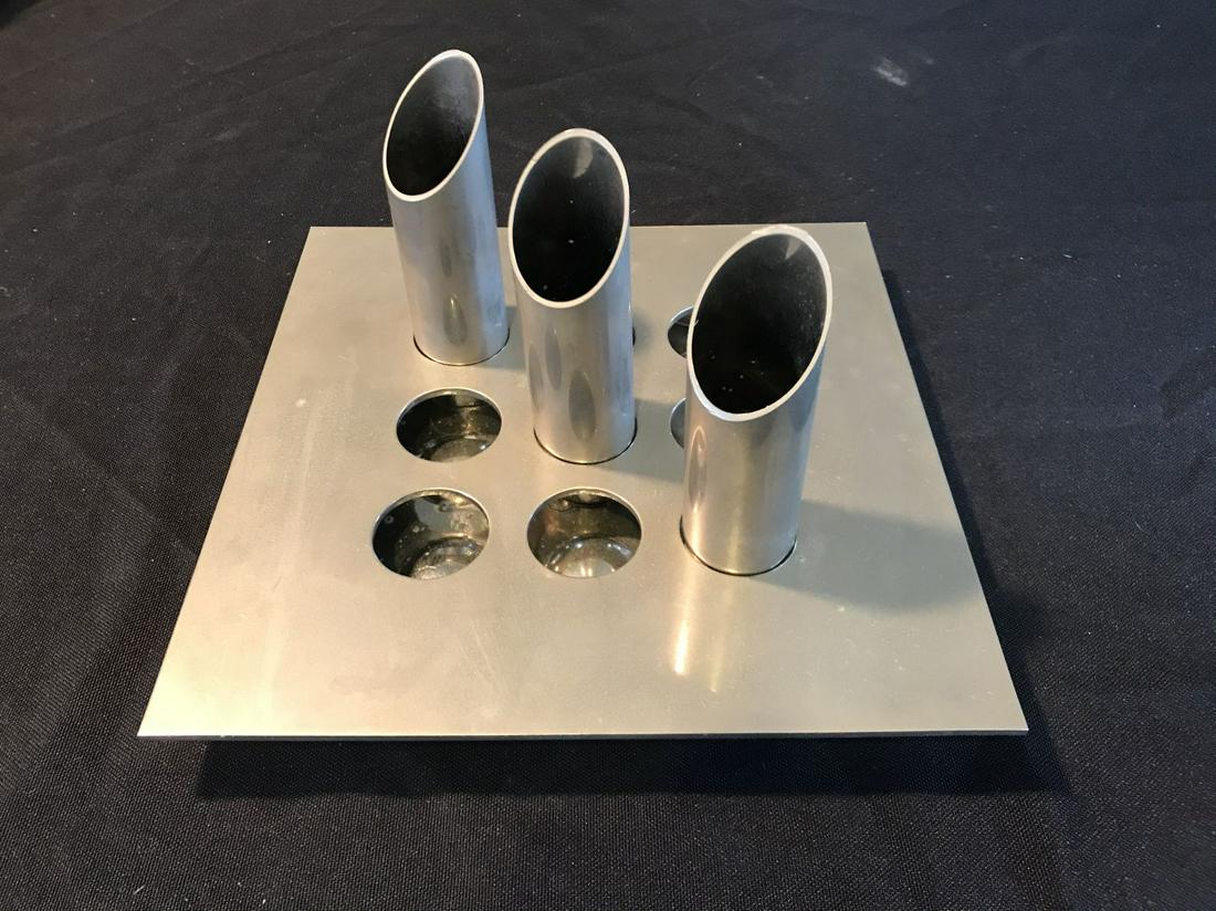 A MARIO FAGGIAN STAINLESS STEEL 4 PART VASE: A fine midcentury functional sculpture vase by Mario Faggian . Three moveable bud vases in a tic tac toe base . High design at its best. 8”x8”x5”