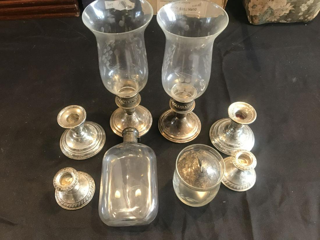 A STERLING SILVER TOPPED FLASK AND SIX WEIGHTED: A STERLING SILVER TOPPED FLASK AND SIX WEIGHTED STERLING CANDLESTICKS. PROPERTY FROM A HUNTINGTON ,MASS ESTATE
