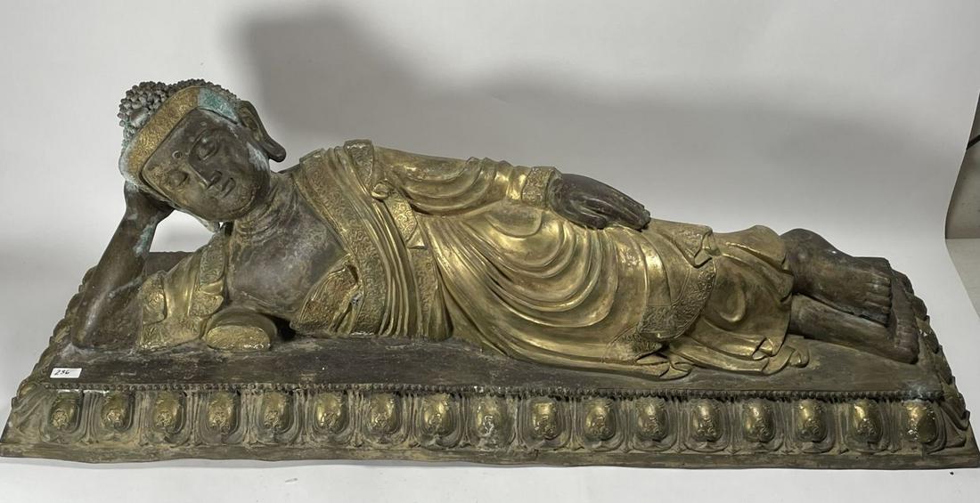 A LARGE PAINTED CHINESE BRONZE LOUNGING BUDDHA 43.5" X: A LARGE PAINTED CHINESE BRONZE LOUNGING BUDDHA 43.5" X 14" X 15"