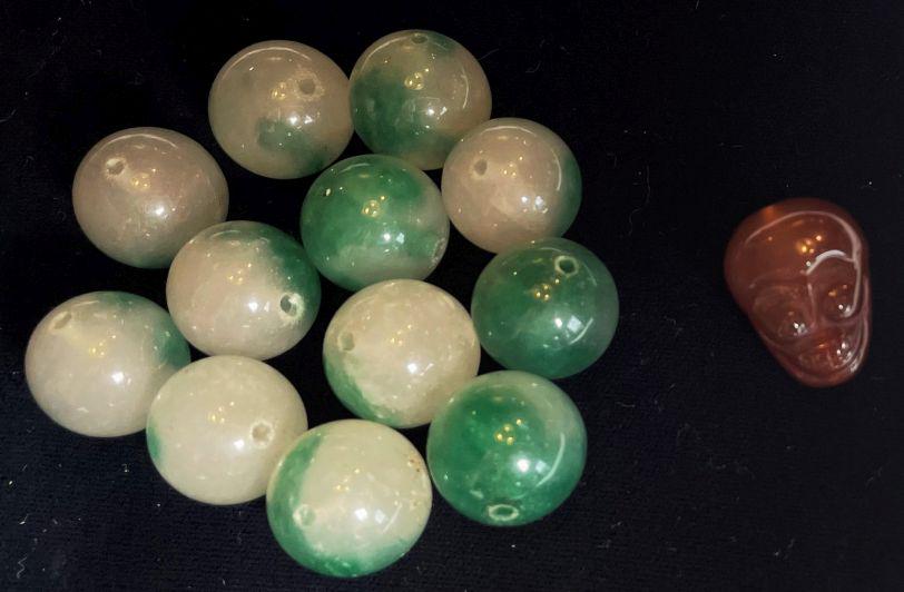 A LOT OF 12 JADEITE BEADS AND ONE CARVED BEAD: A LOT OF 12 JADEITE BEADS AND ONE CARVED BEAD