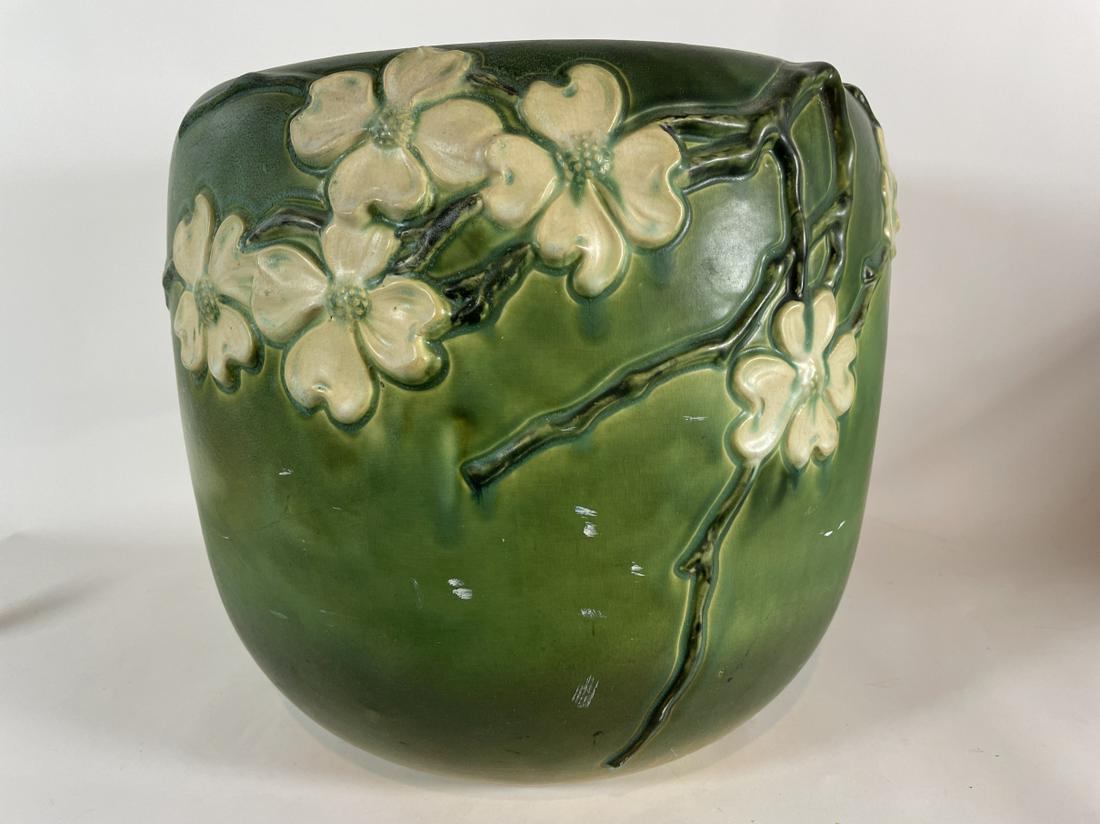 A LARGE GREEN ROSEVILLE JARDINAIRE WITH FLOWER MOTIF,: A LARGE GREEN ROSEVILLE JARDINAIRE WITH FLOWER MOTIF, WITH INTERIOR RIM CHIP AND REPAIR 14" X 13"