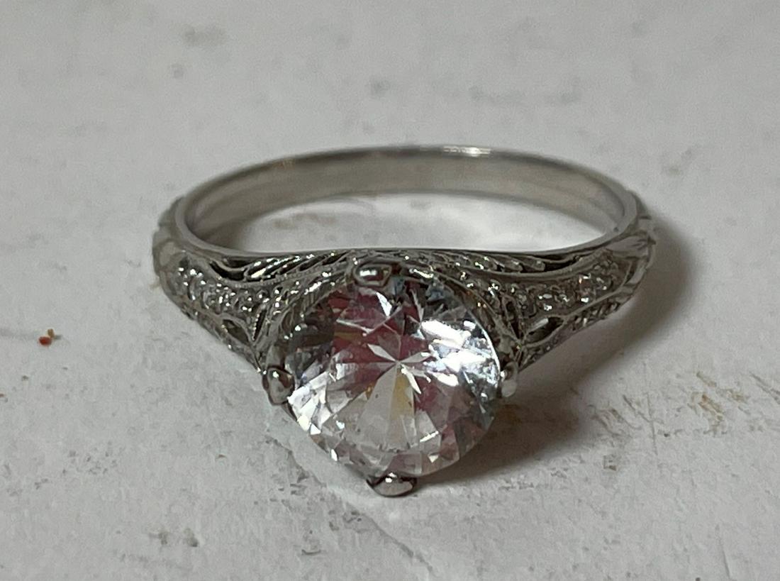 A PLATINUM AND WHITE SAPPHIRE RING IN A PERIOD (1 of 5)