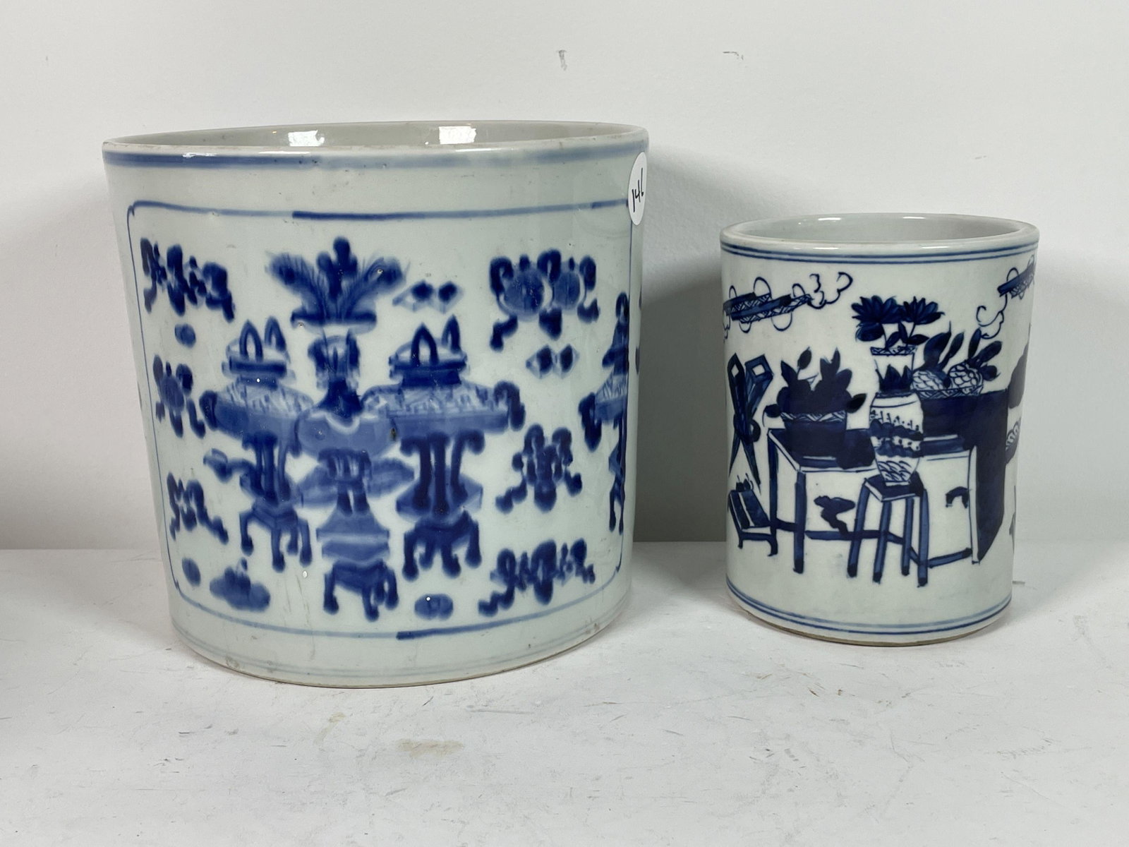 TWO UNMARKED CHINESE BLUE AND WHITE BRUSH POTS, 7" X 8": TWO UNMARKED CHINESE BLUE AND WHITE BRUSH POTS, 7" X 8" AND 5.5" X 4.5". PROPERTY OF A FINE SAG HARBOR ESTATE