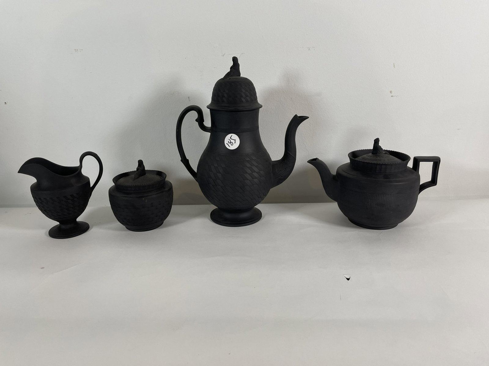A FOUR PIECE HACKWOOD STAFFORDSHIRE BLACK BASALT COFFEE: A FOUR PIECE HACKWOOD STAFFORDSHIRE BLACK BASALT COFFEE AND TEA SERVICE, 12" X 9" AND SMALLER. PROPERTY OF A FINE SAG HARBOR ESTATE