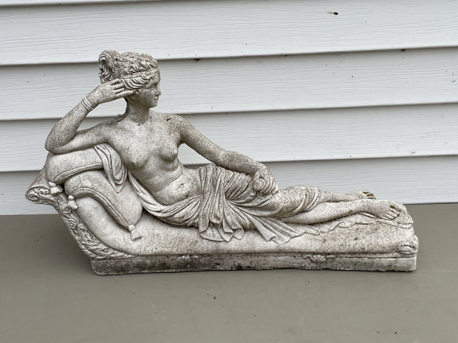 A CAST STONE RECLINING FIGURE OF CLEOPATRA. 20" X: A CAST STONE RECLINING FIGURE OF CLEOPATRA. 20" X 13"PROPERTY OF A FINE SAG HARBOR ESTATE