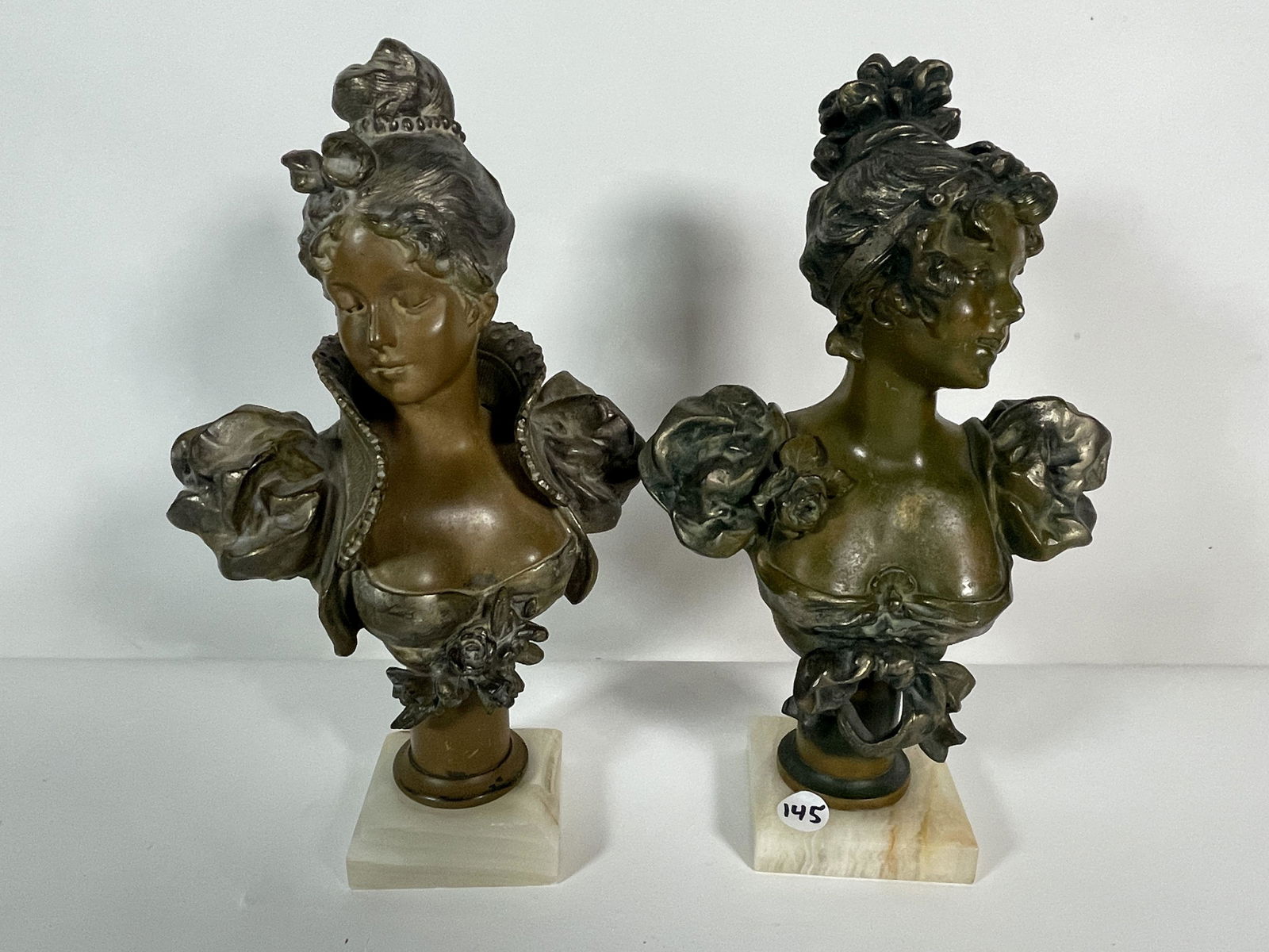 A PAIR OF BRONZE PATINATED BUSTS OF WOMEN ON MARBLE (1 of 3)