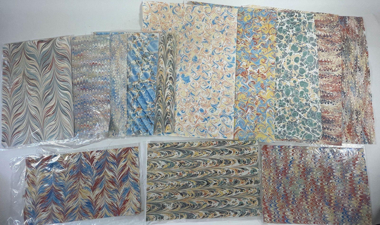 A LARGE LOT OF MARBLED PAPER, TEN 12" X 17.5" SHEETS AND FIVE 22" X 17.5" SHEETS. MANY SIGNED BY (1 of 4)
