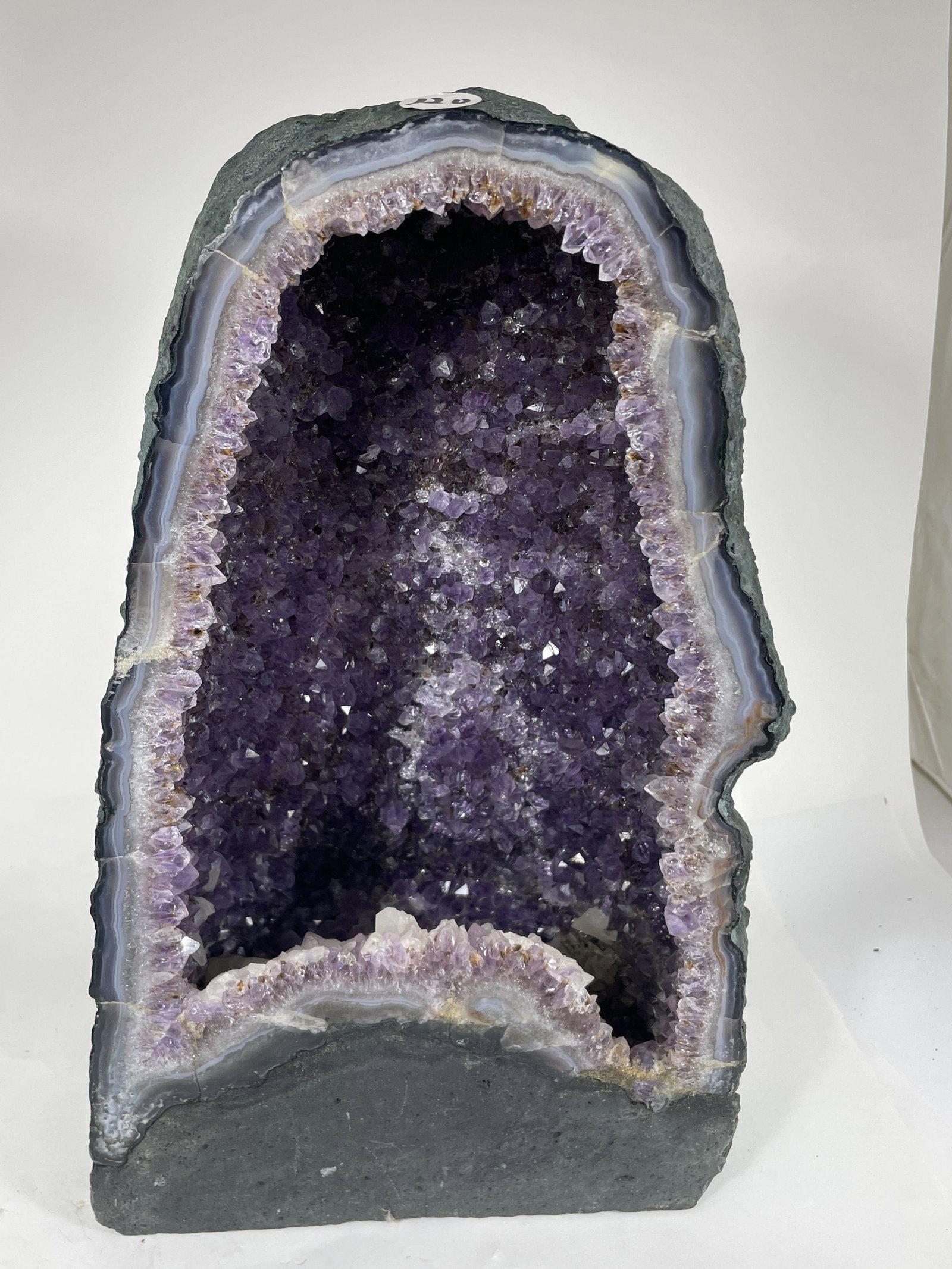 A LARGE AMETHYST GEODE, 8" X 7" X 13": A LARGE AMETHYST GEODE, 8" X 7" X 13"