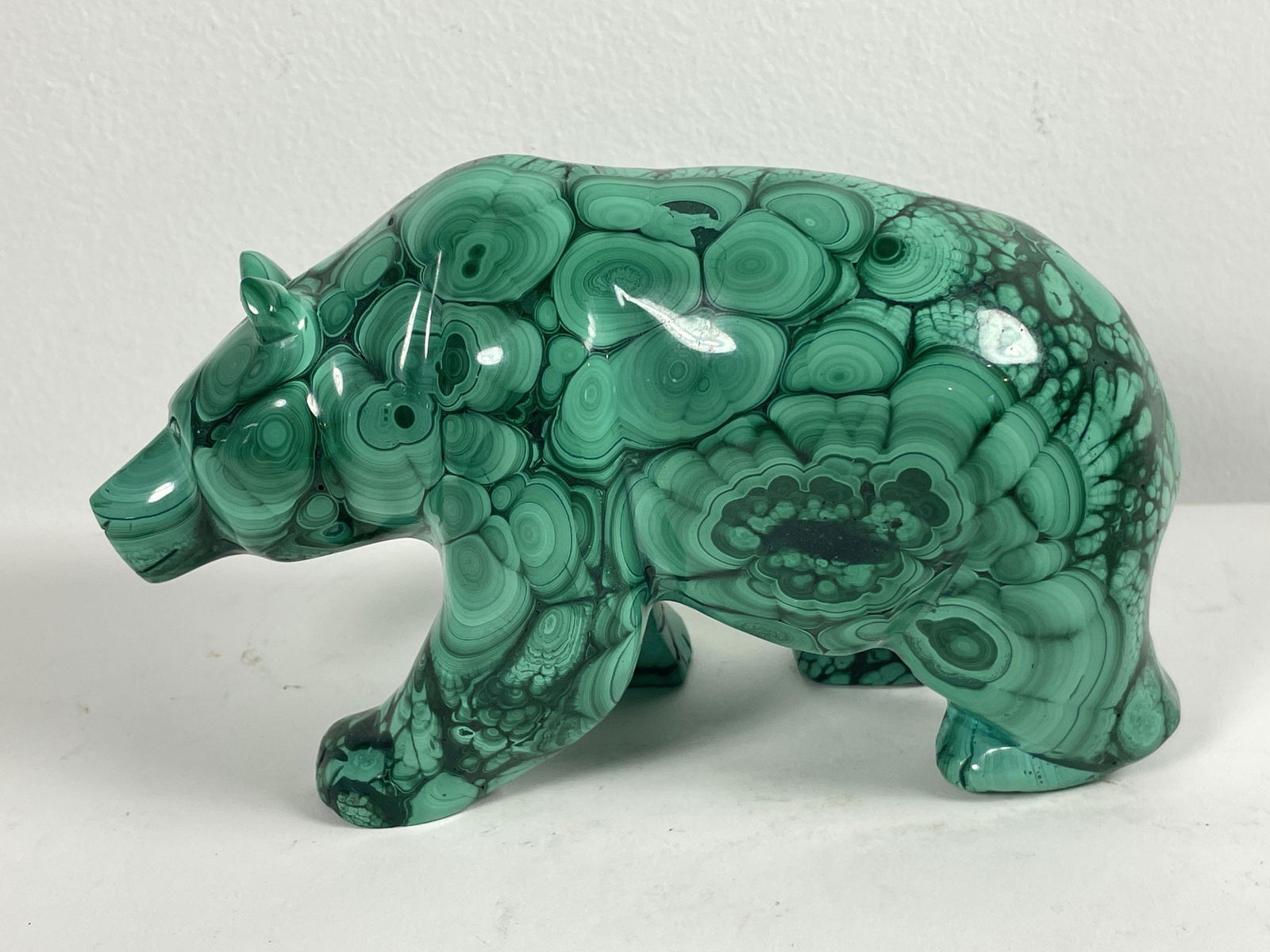 A CARVED BULLSEYE MALACHITE BEAR: A CARVED BULLSEYE MALACHITE BEAR, 7" X 4" X 3"