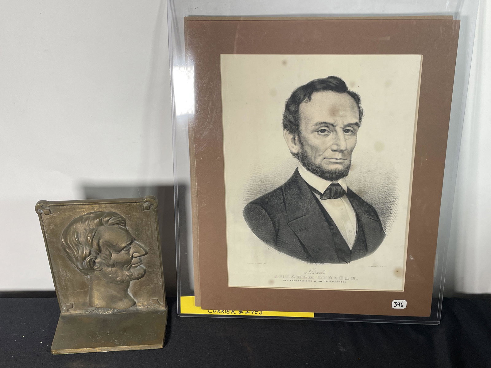 A CURRIER AND IVES PRINT OF LINCOLN AND A BRONZE LINCOLN DOORSTOP: A CURRIER AND IVES PRINT OF LINCOLN AND A BRONZE LINCOLN DOORSTOP, 14.5" X 18" AND 7" X 8.5" X 3.5"