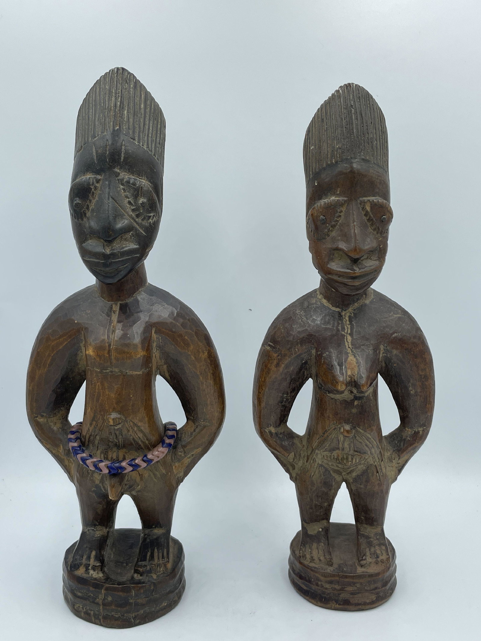 A SET OF ERE IBEJI YORUBA TWIN FIGURES, 10.5" AND 11" PROPERTY FROM THE PRIVATE COLLECTION OF: A SET OF ERE IBEJI YORUBA TWIN FIGURES, 10.5" AND 11" PROPERTY FROM THE PRIVATE COLLECTION OF JANINE AND JOSEF GUGLER. SEE ALSO THE WILLIAM BENTON MUSEUM OF ART COLLECTION OF AFRICAN ART.