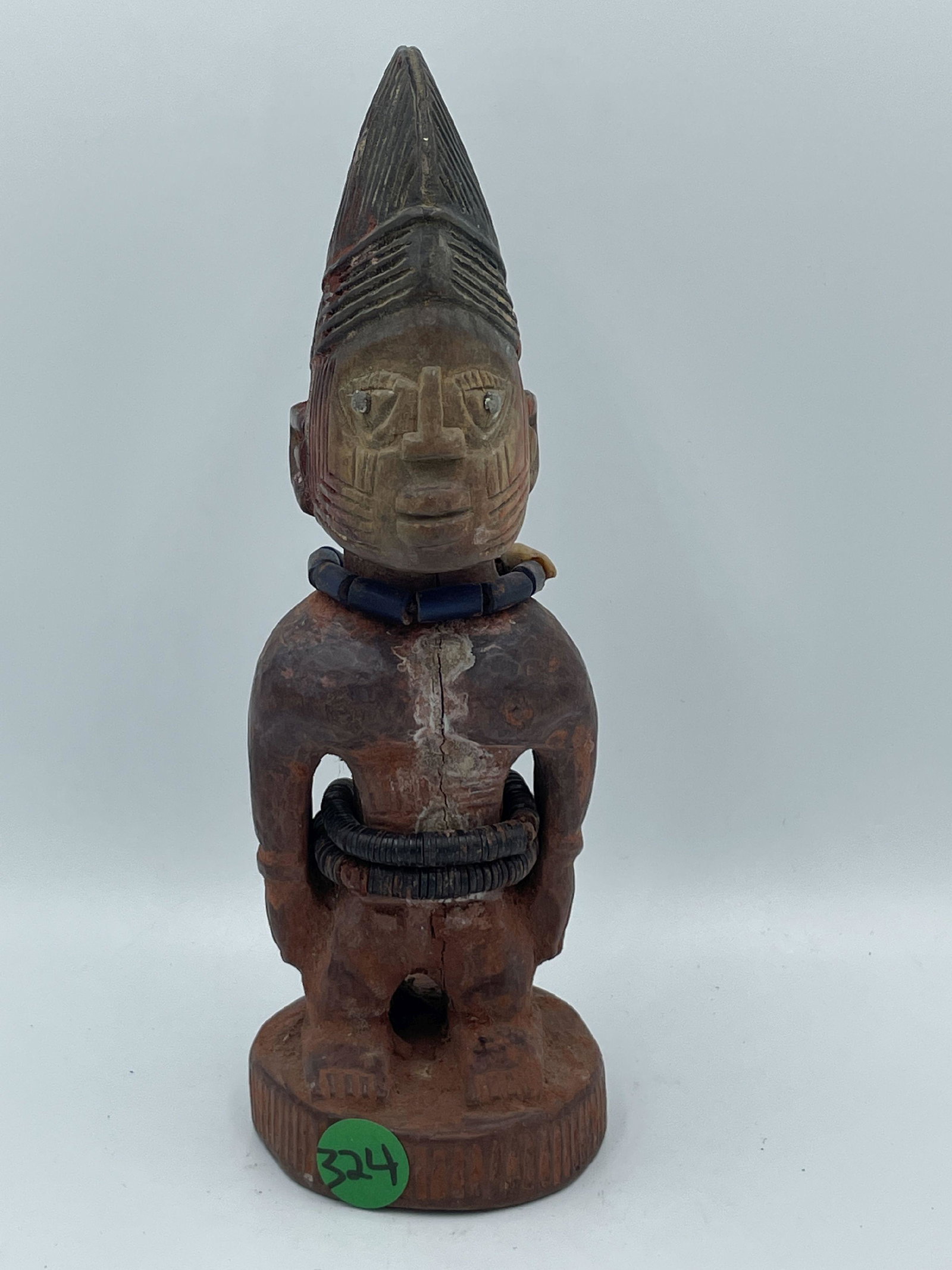 A MALE YORUBA ERE IBEJI FIGURE WITH PAINT AND BEADS, 9" PROPERTY FROM THE PRIVATE COLLECTION OF: A MALE YORUBA ERE IBEJI FIGURE WITH PAINT AND BEADS, 9" PROPERTY FROM THE PRIVATE COLLECTION OF JANINE AND JOSEF GUGLER. SEE ALSO THE WILLIAM BENTON MUSEUM OF ART COLLECTION OF AFRICAN ART.