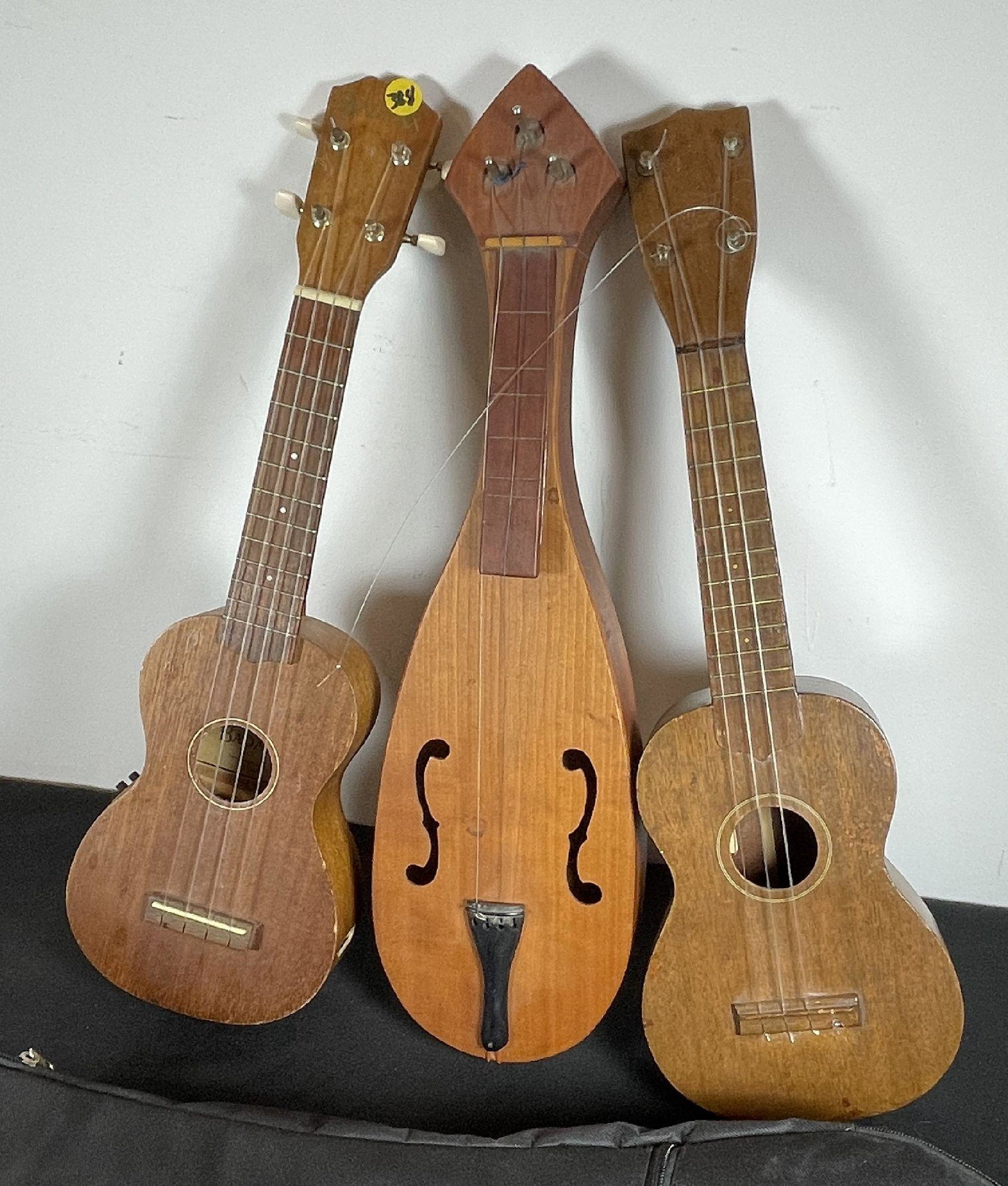 A GRETSCH UKELELE, A BADAXE UKELELE, AND ONE OTHER INSTRUMENT: A GRETSCH UKELELE, A BADAXE UKELELE, AND ONE OTHER INSTRUMENT