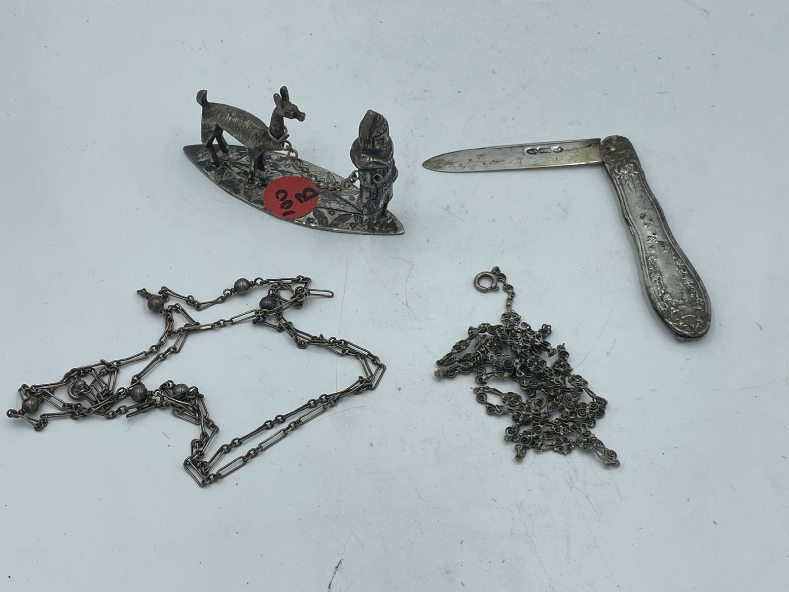 A STERLING SILVER FIGURINE, CHAIN, AND A COIN SILVER FRUIT KNIFE (1 of 6)