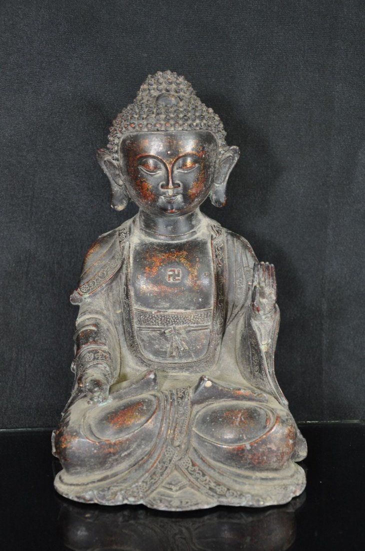 CHINESE BRONZE STATUE: Bronze statue, China, Buddha sitting cross-legged, right hand on leg, left hand raised up. 10.5"T