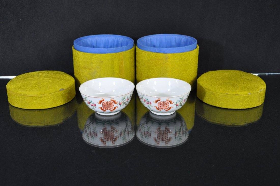 A PAIR OF 19TH C. CHINESE FAMILLE ROSE PORCELA: Porcelain bowls, China, 19th c. decorated with a peach tree and bats on the outside, six red Chinese characters marked on base. Comes with original box. 2"T 4.5"D