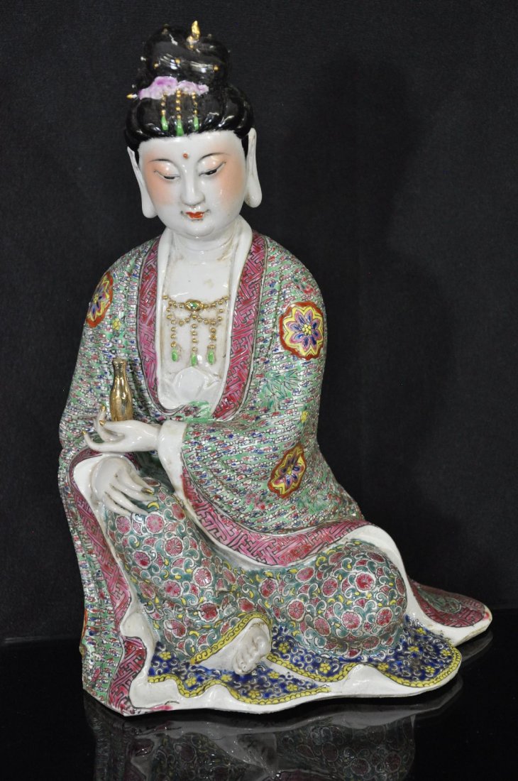 19TH / 20TH C. CHINESE FAMILLE ROSE PORCELAIN: Porcelain statue, of a sitting guanyin figure, right knee raised, left hand holding a vase, right hand on knee. three carved Chinese characters marked on base. Repair to right hand. 12.5"T