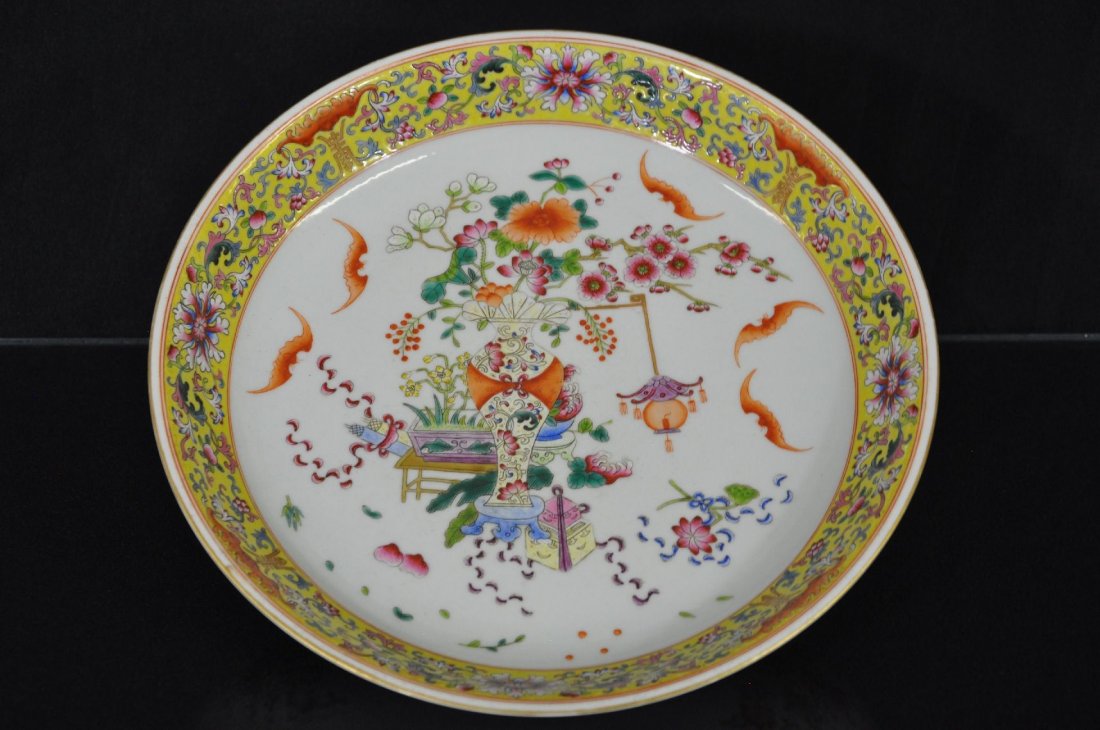 19TH C. CHINESE FAMILLE ROSE PLATE: Porcelain plate decorated with plum flowers, peonies, lotus flowers in a vase, 5 bats flying around the flowers, six Chinese characters marked on base. 12"D