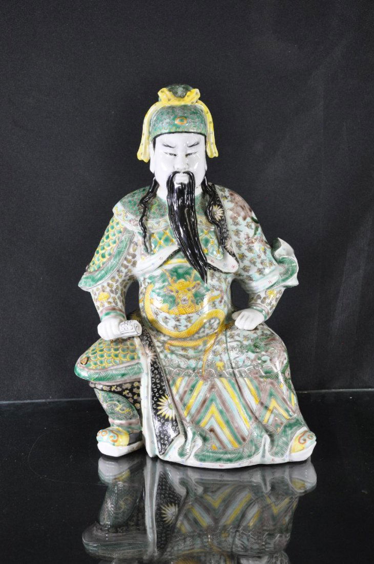 19TH / 20TH C. CHINESE FAMILLE ROSE PORCELAIN: Porcelain statue, China, man sitting down, both hands on legs, right hand holding scroll, six Chinese characters marked on base. 15"T