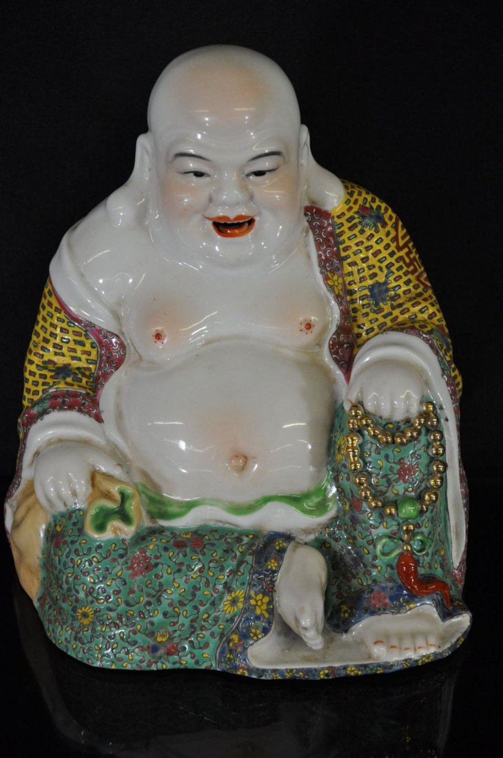 19TH / 20TH C. CHINESE FAMILLE ROSE PORCELAIN: Porcelain statue, sitting with left knee raised, left hand resting on knee holding prayer beads, right hand resting on thigh holding a bag, eight Chinese characters marked on base. 8.5"T