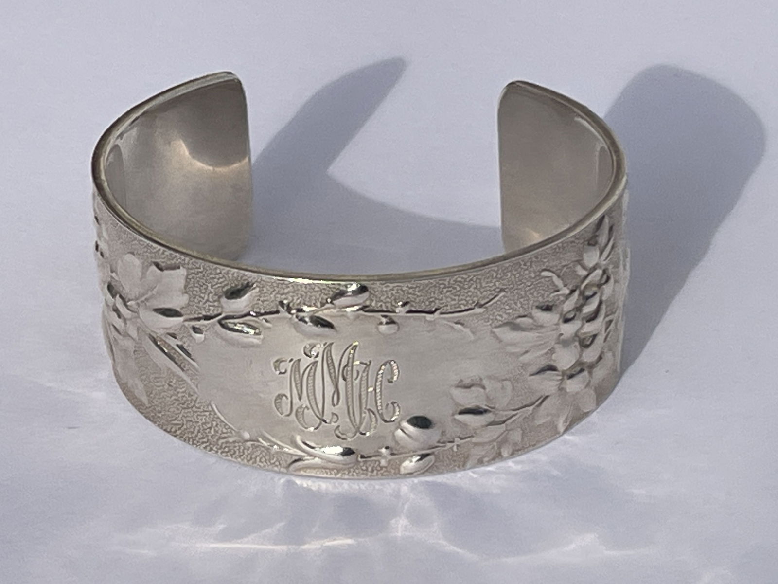 A TIFFANY AND CO. STERLING SILVER FLORAL DECORATED BANGLE BRACELET (1 of 7)
