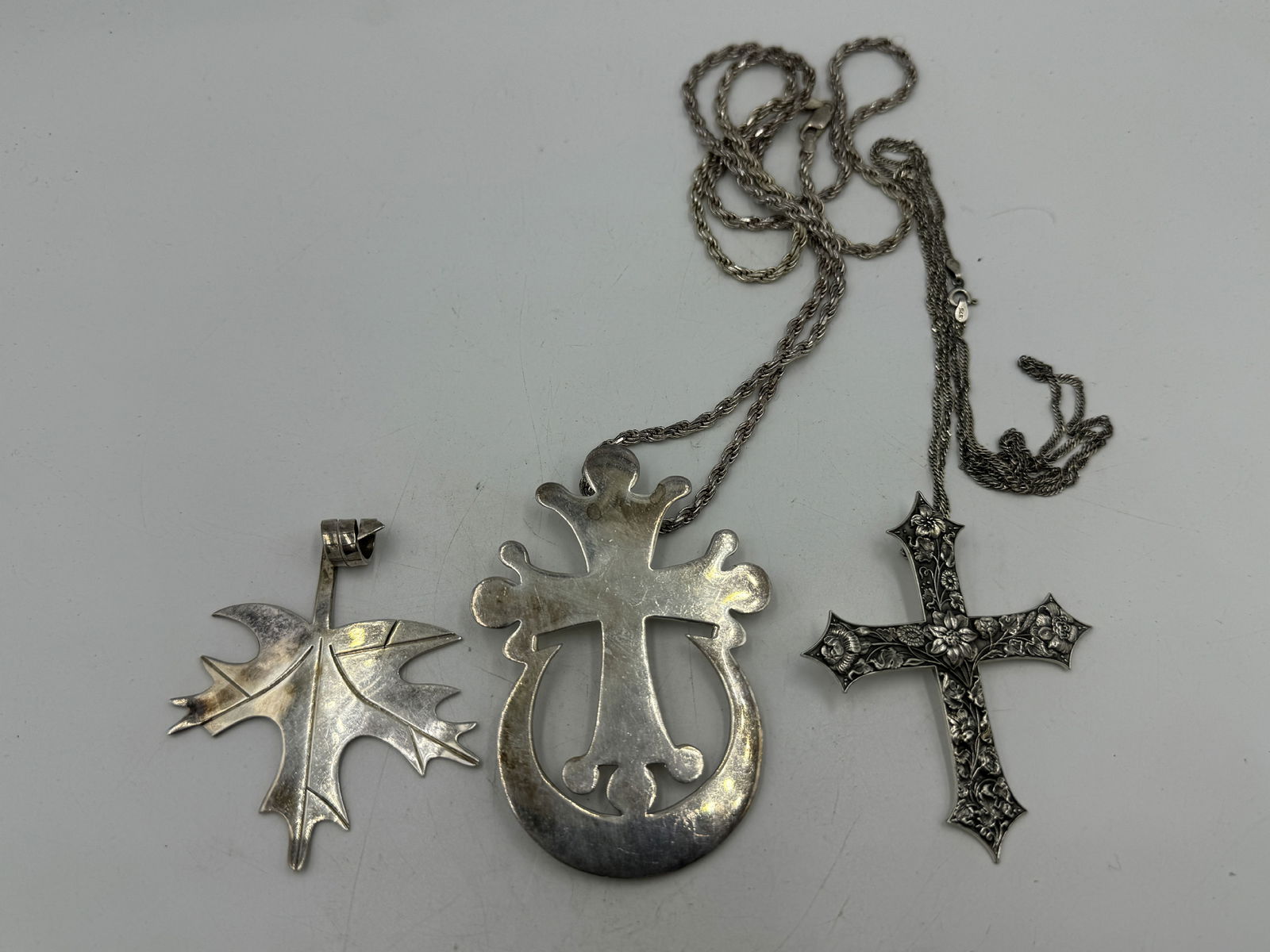 THREE STERLING SILVER NECKLACES, 2 CROSSES AND ONE MAPLE LEAF. 98.1 GRAMS (1 of 6)