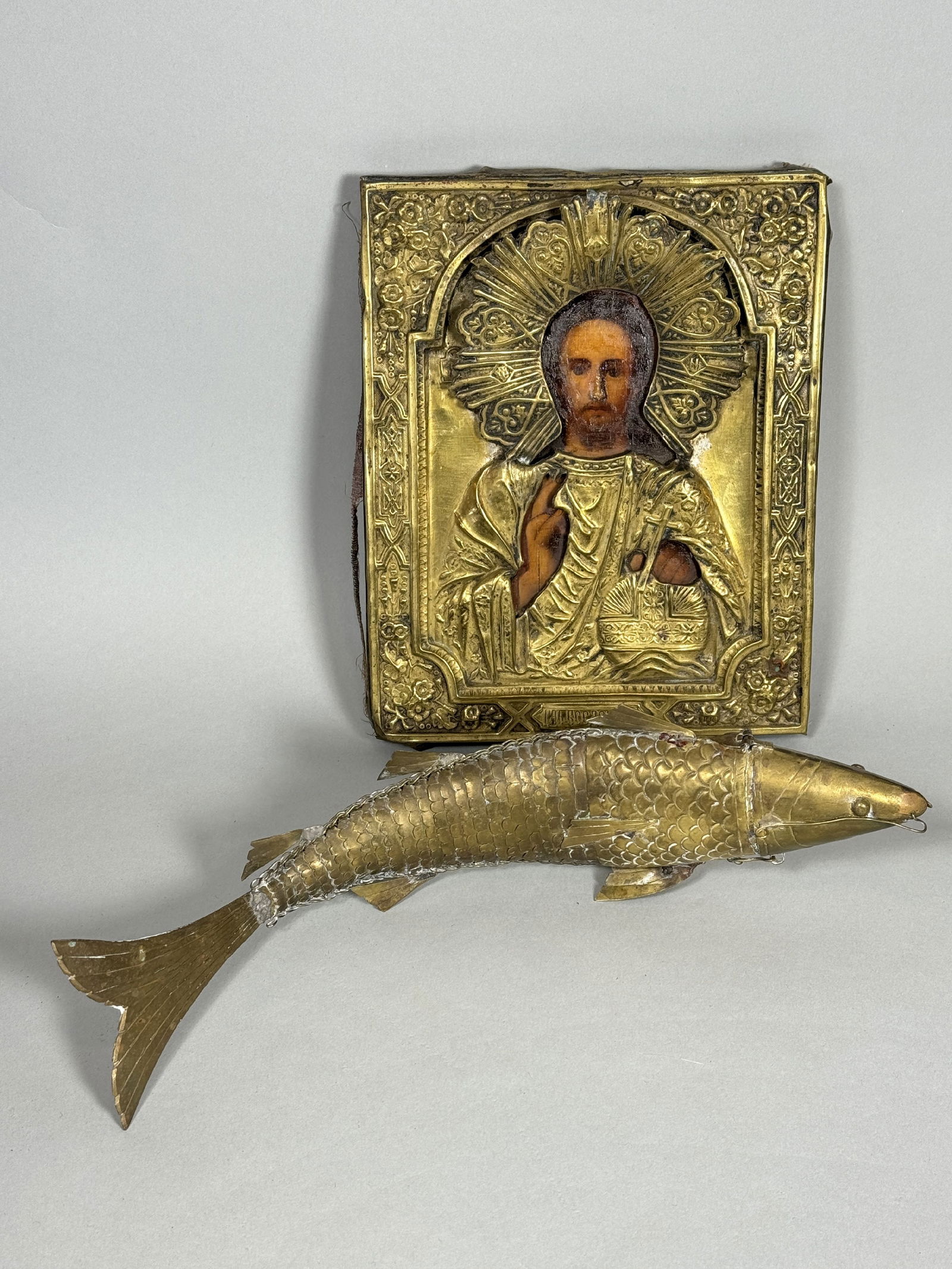 A 19TH CENTURY ICON TEMPURA PAINT ON WOOD AND A ARTICULATING BRASS FISH, 9" X 7" AND 13" LONG (1 of 7)