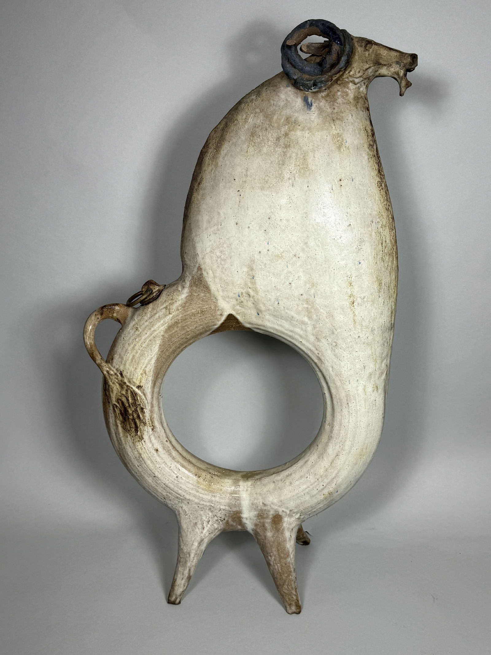 A LARGE MIDCENTURY POTTERY DECANTER IN THE FORM OF A RAM, 15" X 4" X 27" (1 of 9)