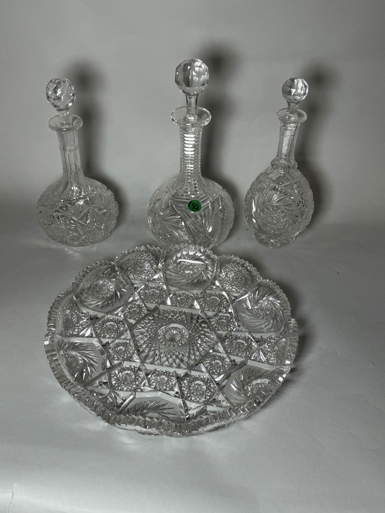 THREE CUT CRYSTAL DECANTERS W/ A CUT CRYSTAL TRAY. 11", 10", 10" AND 12" DIAMETER (1 of 8)