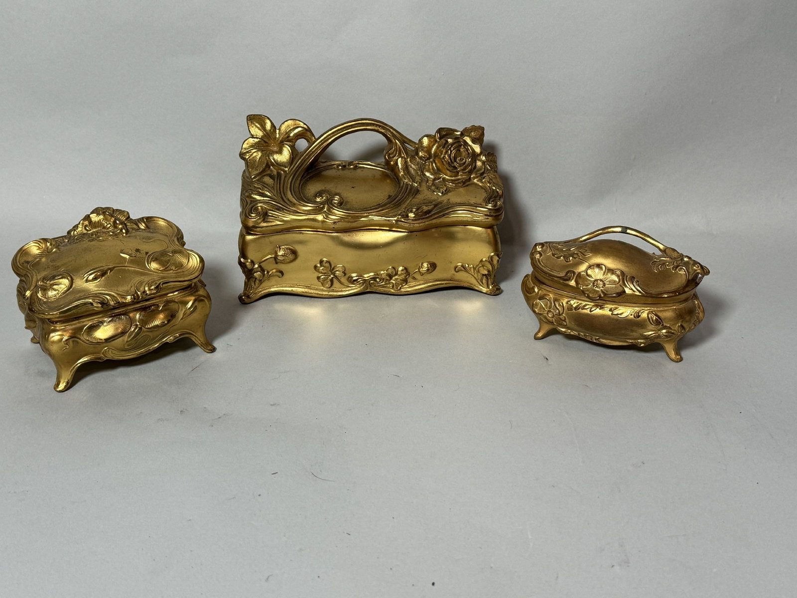 THREE ART NOUVEAU GILT METAL CASKETS, 7" X 5" X 3": THREE ART NOUVEAU GILT METAL CASKETS, 7" X 5" X 3"
