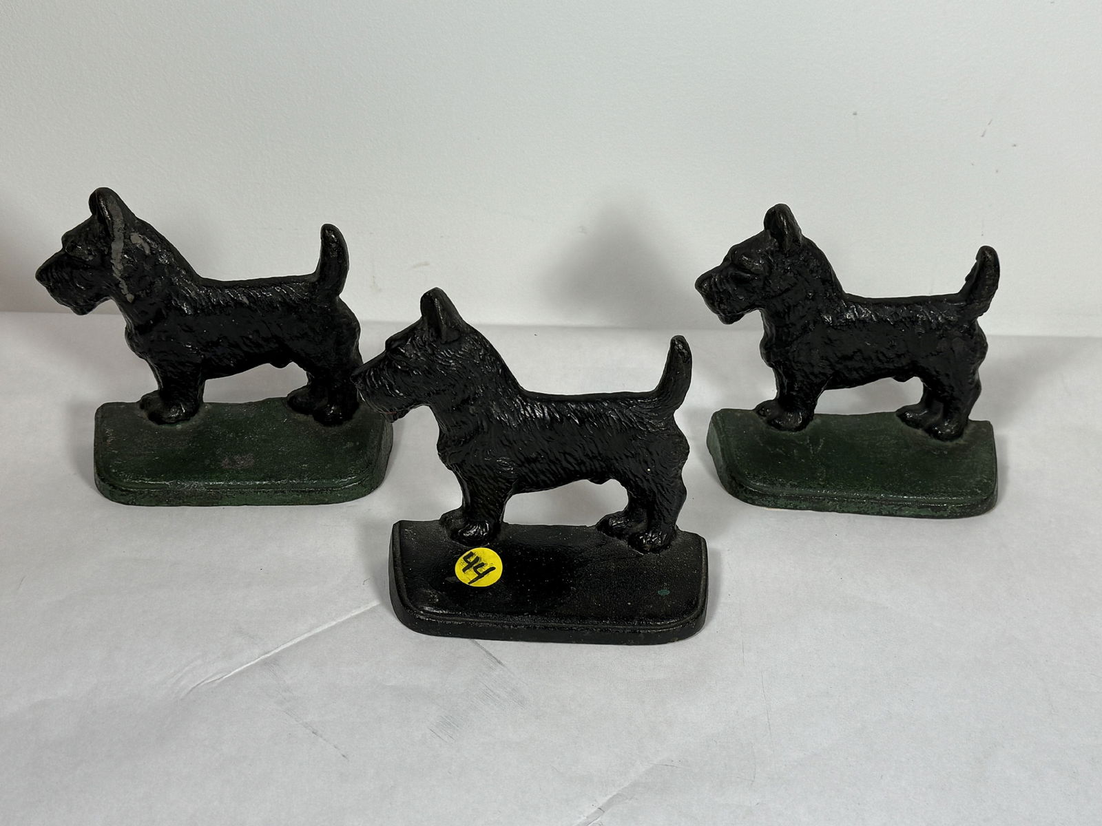 THREE ANTIQUE CAST IRON SCOTTIE DOG SOORSTOPS, 5.5" X 5" EACH (1 of 5)